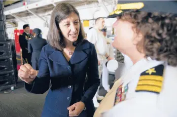  ?? STEVE HELBER/AP ?? Rep. Elaine Luria, D-VA., speaks to a naval officer July 15 aboard the USS Kearsarge at Naval Station Norfolk in Virginia. Luria, a Navy veteran, defeated incumbent Republican Scott Taylor, a former SEAL, for office in 2018 and in 2020.