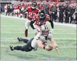  ?? Curtis Compton / Atlanta Journal-Constituti­on via AP ?? New Orleans QB Drew Brees dives into the end zone past Atlanta’s Brian Poole and Robert Alford to tie their game 37-37 and send it to overtime. The Saints went on to win on another Brees keeper.