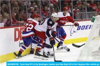  ??  ?? WASHINGTON: Travis Boyd #72 of the Washington Capitals and Riley Nash #20 of the Columbus Blue Jackets go after the puck in the second period at Capital One Arena on Saturday in Washington,. — AFP