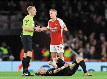  ?? ?? It could be play-acting: arsenal’s Oleksandr Zinchenko remonstrat­ing with referee Craig pawson as luton’s daiki Hashioka lies down after sustaining an injury during their match on Wednesday. — Reuters
