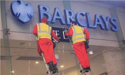  ?? Photograph: Jiri Rezac/Greenpeace ?? Greenpeace activists deface a Barclays branch to draw attention to climate change.