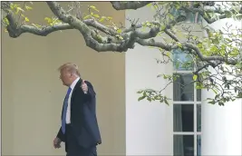  ?? PATRICK SEMANSKY — THE ASSOCIATED PRESS ?? President Donald Trump gestures to members of the press on Thursday as he walks to the Oval Office of the White House in Washington.