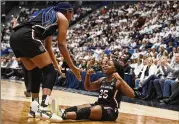  ?? JESSICA HILL/ASSOCIATED PRESS ?? South Carolina’s Raven Johnson (25) reacts to teammate Aliyah Boston during the first half of Sunday’s game in Hartford, Conn. Boston had 26 points and 11 rebounds for undefeated South Carolina.