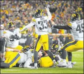 ?? The Associated Press ?? Craig Lassi
Iowa’a Yahya Black (94), Riley Moss (33) and Ethan Hurkett celebrate Saturday after the Hawkeyes recovered a late fumble during a 13-10 win at Minnesota.