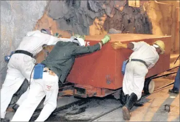  ?? PHOTO: BLOOMBERG ?? Miners push a box of explosives several kilometres below ground at AngloGold Ashanti’s Mponeng Mine. Not much exploratio­n has been done in the past 10 years, and all the mines’ assets’ lives are getting shorter.