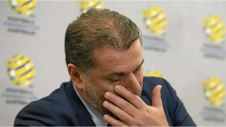  ??  ?? EMOTIONAL: Ange Postecoglo­u wipes away tears as he announces his resignatio­n as Socceroos coach. PHOTO: AAP