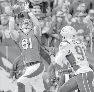  ?? Joe Mahoney / Associated Press ?? Denver tight end Owen Daniels (81) was on the receiving end of two touchdown passes from Peyton Manning, including this 12-yard score against New England linebacker Jamie Collins in the first half.