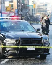  ?? NICK PROCAYLO / POSTMEDIA NEWS ?? The scene Sunday of an overnight shooting on West Broadway Avenue in Vancouver. A 15-year-old Coquitlam boy who was hit by gunfire while out with his family has died, as did one of the gunmen involved.