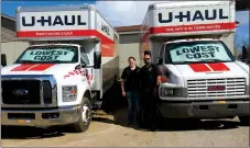  ?? Photo by Susan Holland ?? Erin and Ricky Sehgal, owners of the Gravette Station, posed last week with a couple of the large U-Haul trucks that are available for rental at the station.