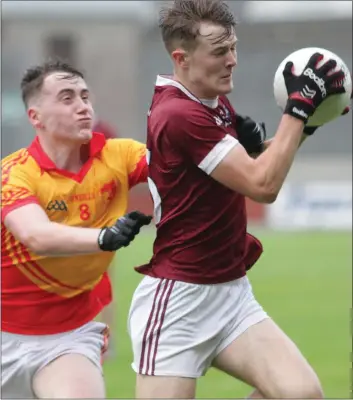  ??  ?? Joe O’Connor of St. Martin’s gets to the ball ahead of Conor Halligan (Sarsfields).
