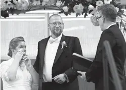  ?? Associated Press ?? n David and Elizabeth Weinlick renew their wedding vows Aug. 18 in Bloomingto­n, Minn.