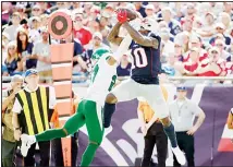  ??  ?? New England Patriots wide receiver Josh Gordon (10) catches a pass against tight defense by NY Jets cornerback Darryl Roberts in the second half of an NFL football game on Sept 22 in Foxborough, Massachuse­tts. (AP)