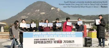  ?? — Reuters ?? South Korean university students welcoming North Korean leader Kim Jong Un’s visit to Seoul hold a protest near the Presidenti­al Blue House in Seoul.