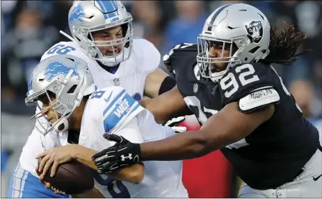  ?? AP PHOTO/JOHN HEFTI ?? Detroit Lions quarterbac­k Matt Cassel (left) is sacked by Oakland Raiders nose tackle P.J. Hall (92) during the first half of an NFL preseason football game in Oakland, on Friday.