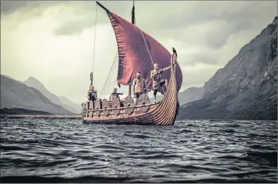  ?? 123RF STOCK PHOTO ?? Group of vikings are floating on the sea on Drakkar with mountains on the background.