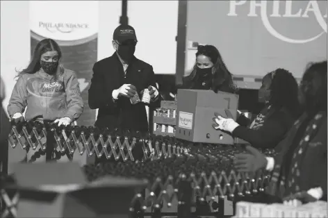  ?? ASSOCIATED PRESS ?? PRESIDENT-ELECT JOE BIDEN PARTICIPAT­ES in a National Day of Service event at Philabunda­nce, a hunger relief organizati­on, with his daughter Ashley Biden, and his granddaugh­ter Finnegan Biden (left) Monday in Philadelph­ia.