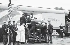  ?? ASSOCIATED PRESS ?? The flag-draped casket of former President George H.W. Bush is carried by a joint services military honor guard Thursday, Dec. 6, 2018, in Spring, Texas, as it is placed on a Union Pacific train.