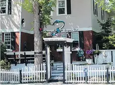  ??  ?? A 300-pound dragon statue stood watch over the Dragon’s Nest bed and breakfast in the Cathedral neighbourh­ood until it was stolen this week.