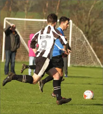  ??  ?? Glen Hughes of Courtown Hibs is chased by Richie Walsh of Corach Ramblers during their FAI Junior Cup fourth round match on Sunday.