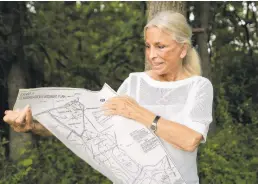  ??  ?? McCloskey, of Newtown Square, looks over a property map of a plot of land in the Brandywine Valley in Chester County on June 3.