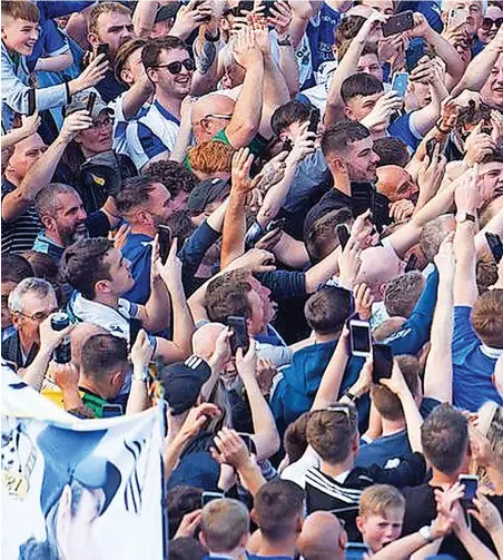  ?? ?? Joey Barton is carried on the shoulders of a Rovers fan following the promotion-clinching win against Scunthorpe