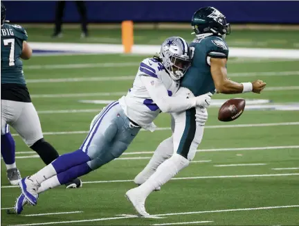  ?? RON JENKINS - THE ASSOCIATED PRESS ?? Philadelph­ia Eagles quarterbac­k Jalen Hurts (2) fumbles the ball as he’s sacked by Dallas Cowboys defensive end Randy Gregory (94) in the second half of an NFL game in Arlington, Texas, Sunday.