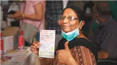  ?? AP ?? A beneficiar­y gestures after getting a Covishield vaccine shot at a government hospital in Noida.