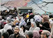  ?? /Reuters ?? Desperate: Palestinia­ns gather to receive aid outside a warehouse as Gaza residents face crisis levels of hunger, amid the ongoing conflict between Israel and Hamas, in Gaza City on Monday.