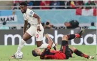  ?? (AFP) ?? Canada’s forward Alphonso Davies runs with the ball as Belgium’s midfielder Youri Tielemans falls during the FIFA World Cup Qatar 2022 Group F match at the Ahmad Bin Ali Stadium, recently.