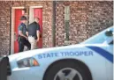  ?? JIM WEBER/THE COMMERCIAL APPEAL ?? Arkansas state police investigat­e the scene of a robbery at the America’s Best Value Inn in West Memphis, Arkansas.