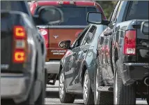  ?? RALPH BARRERA / AMERICAN-STATESMAN ?? Motorists endure lines early Friday at the H-E-B at North Lemar and Rundberg. Gas supplies are expected to start returning to normal early next week as more refineries reopen.