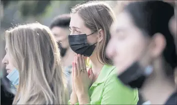  ?? DAI SUGANO — STAFF PHOTOGRAPH­ER ?? Santa Clara University freshman Maisie McDermid, center, listens to a speaker during a rally demanding better counseling and mental health services for all students Thursday at Santa Clara University in Santa Clara.