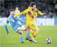  ?? REUTERS ?? Barca’s Lionel Messi, right, vies with Napoli’s Lorenzo Insigne in Naples.