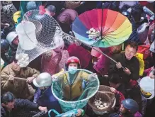  ?? FU JIANBIN / FOR CHINA DAILY ?? People scramble for rice cakes to celebrate the establishm­ent of a new activity center in Qifeng village in Duchang, Jiangxi province, on Nov 29. There is a custom of throwing rice cakes in Jiangxi’s rural areas when a new building is completed.