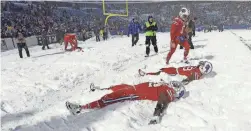  ?? ADRIAN KRAUS/AP ?? Bills players make snow angels after defeating the Colts in 2017 in Orchard Park, N.Y.
