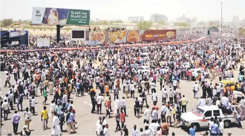  ??  ?? Sudanese demonstrat­ors gather after Auf said that Bashir had been detained ‘in a safe place’ and that a military council would run the country for a two-year transition­al period outside the Defence Ministry in Khartoum, Sudan.