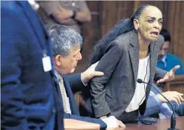  ?? CARL JUSTE/MIAMI HERALD ?? Ana Maria Cardona has an emotional outburst while addressing the court as she proclaims her innocence after being found guilty in the murder of her son.