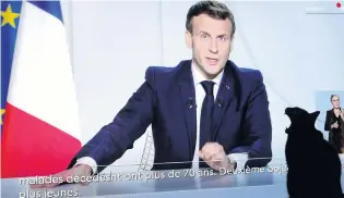  ?? PHOTO: REUTERS ?? Restrictio­ns return . . . A cat is pictured as French President Emmanuel Macron is seen on a screen addressing the nation about the state of the Covid19 outbreak in Nice, France, yesterday.