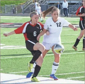  ??  ?? LFO’s Faith Jones (left) battles with Ridgeland’s Marina Mosgrove (right) for possession of the ball during last week’s match in Rossville. The Lady Warriors picked up the 6-1 win. (Photo by Scott Herpst)