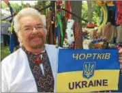  ??  ?? Above, Saratoga Springs cardiologi­st Dr. Andrij Baran displays the blue and gold Ukrainian flag. He chairs an organizing committee that puts on the Capital District Ukrainian Festival. At left, A 17th-century gunpowder flask used by Cossacks is displayed.