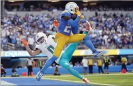  ?? ASHLEY LANDIS — THE ASSOCIATED PRESS ?? Chargers cornerback J.C. Jackson intercepts a pass in the end zone intended for Miami’s Braxton Berrios on Sunday. The Chargers lost 36-34.