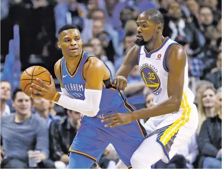  ?? PHOTOS BY SUE OGROCKI/THE ASSOCIATED PRESS ?? Oklahoma City Thunder guard Russell Westbrook, left, keeps the ball from Golden State Warriors forward Kevin Durant during Wednesday’s game in Oklahoma City.