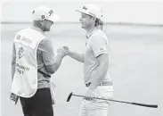  ?? Stacy Revere / Getty Images ?? Australia’s Cameron Smith, right, shot an 11-under 60 to set a course record at Liberty National.