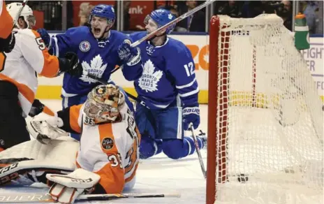  ?? RICK MADONIK/TORONTO STAR ?? Zach Hyman roars, beside linemate Connor Brown, after beating Flyers netminder Steve Mason to put the Leafs up to stay in Friday’s win at the ACC.