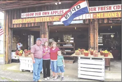  ?? Courtesy photo ?? Andy Baldwin, left, poses with his grandmothe­r, Cecil Baldwin, and Patty Atkins with her son Westin at the family's newly reopened roadside stand.