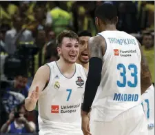  ??  ?? In this May 20 file photo, Real Madrid’s Luka Doncic (left) reacts with teammate Trey Thompkins after winning their Final Four Euroleague final basketball match against Fenerbahce, in Belgrade, Serbia. AP PHOTO/DARKO VOJINOVIC