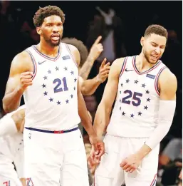  ?? (AFP) ?? Joel Embiid (left) and Ben Simmons of the Philadelph­ia 76ers celebrate their win over the Brooklyn Nets at Barclays Center Sunday in the Brooklyn borough of New York City.