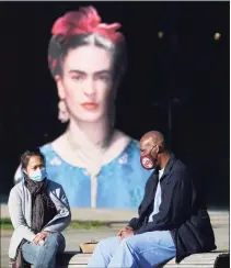  ?? Paul Chinn / The Chronicle ?? Visitors wear masks in front of a museum where a Frida Kahlo exhibit is displayed in San Francisco, Calif., on Saturday.