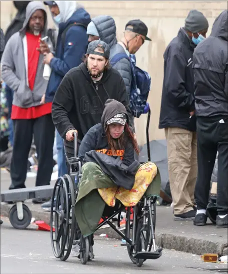  ?? MATT STONE / HERALD STAFF FILE ?? ‘INCLUSIVE, EXTENSIVE AND TIMELY:’ People congregate on Atkinson Street, where drug use and crime is a daily occurrence, on April 26 in Boston.