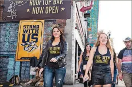  ?? TIMES PHOTOS BY JAKE GILES NETTER/THE NEW YORK ?? A bacheloret­te party roams Broadway in Nashville, Tenn., April 27. “They can be a bit loud or a bit messy, but we love them,” says Butch Spyridon, the chief of the city’s convention bureau, of the pre-wedding parties.